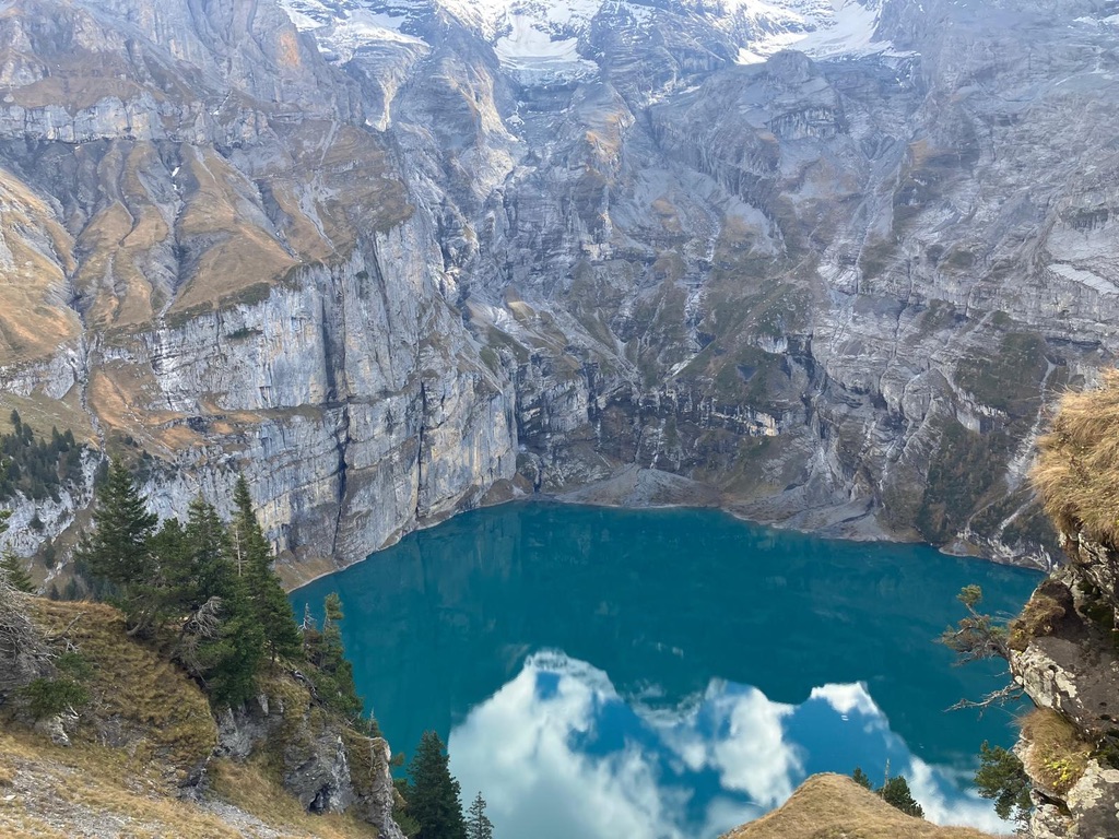 Turquoise alpine lake surrounded by mountains