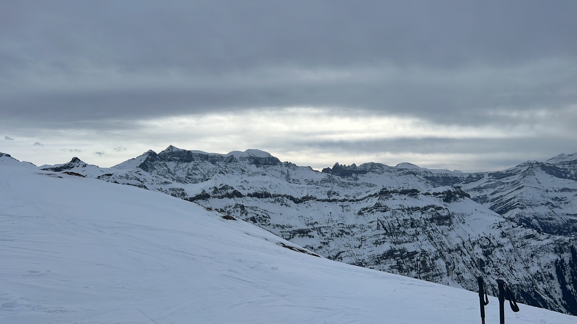 Alpine ridgeline view with ski poles